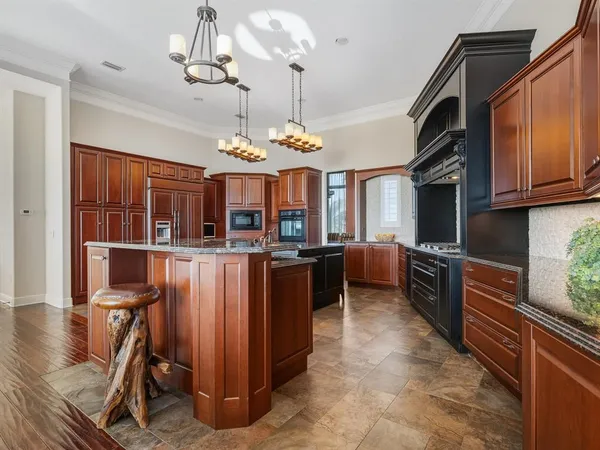 a view of a dining room with furniture wooden floor and chandelier