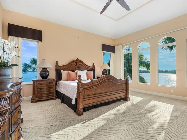 front view of house with a yard and palm trees