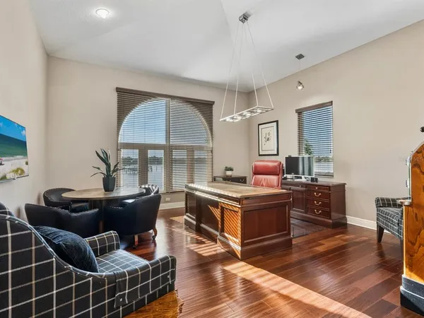 a living room with furniture and a floor to ceiling window