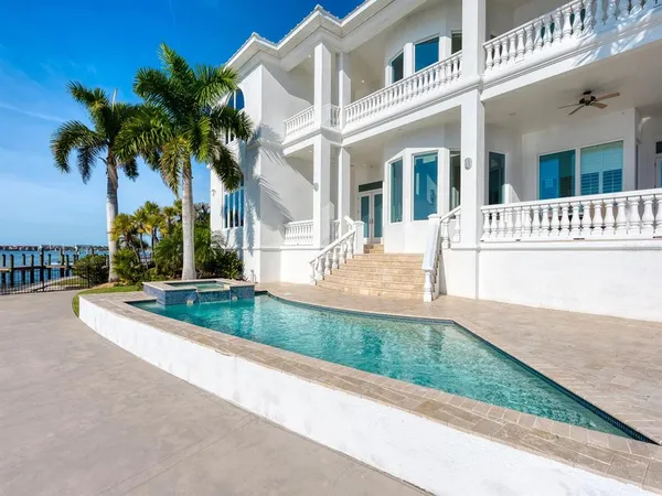 a kitchen with stainless steel appliances granite countertop a kitchen island a stove and a sink