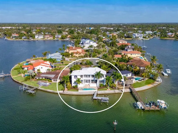 an aerial view of a house with outdoor space and lake view