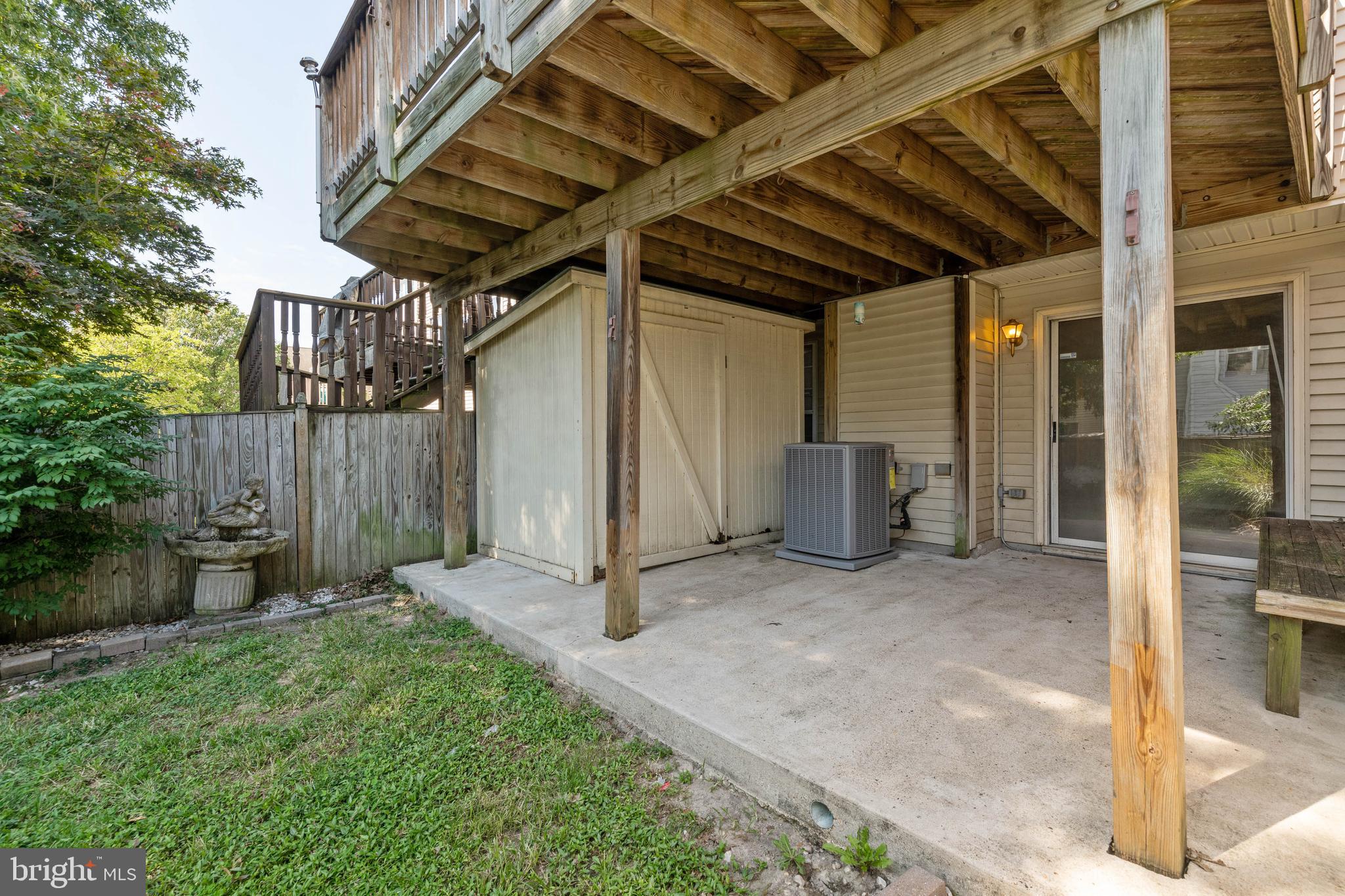 4403 Cole Farm Road Baltimore, MD 21236 - Photo 27 of 30 a view of a backyard with large trees and wooden fence