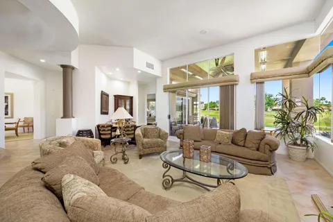 a living room with furniture or couch and a large window