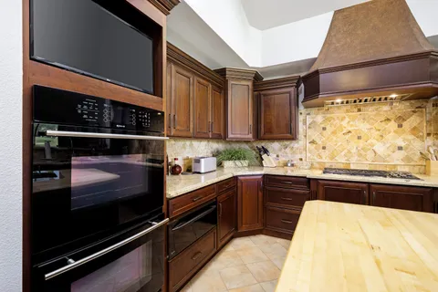 a kitchen with a sink and wooden cabinets