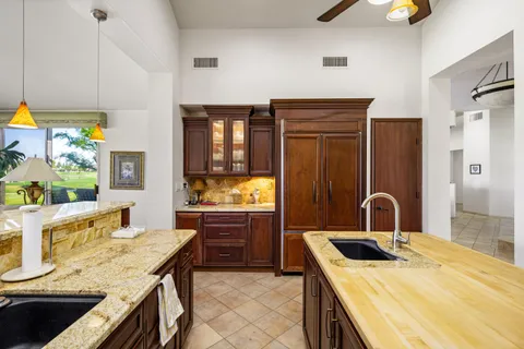 a kitchen with a stove a sink and a refrigerator