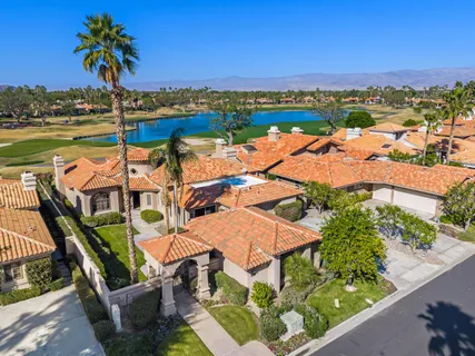 an aerial view of a house with outdoor space and lake view
