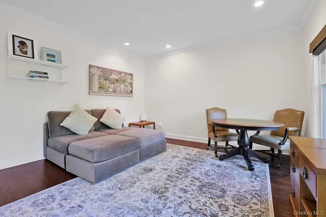 a living room with couches and painting on the wall