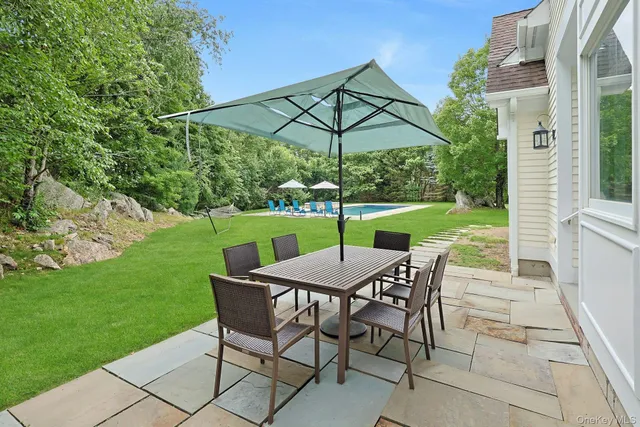a view of an outdoor sitting area with furniture and backyard