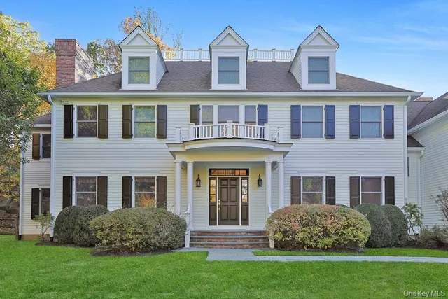 a front view of a brick house with a yard
