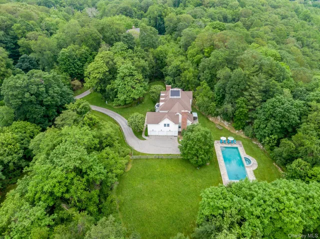 an aerial view of a house with a yard