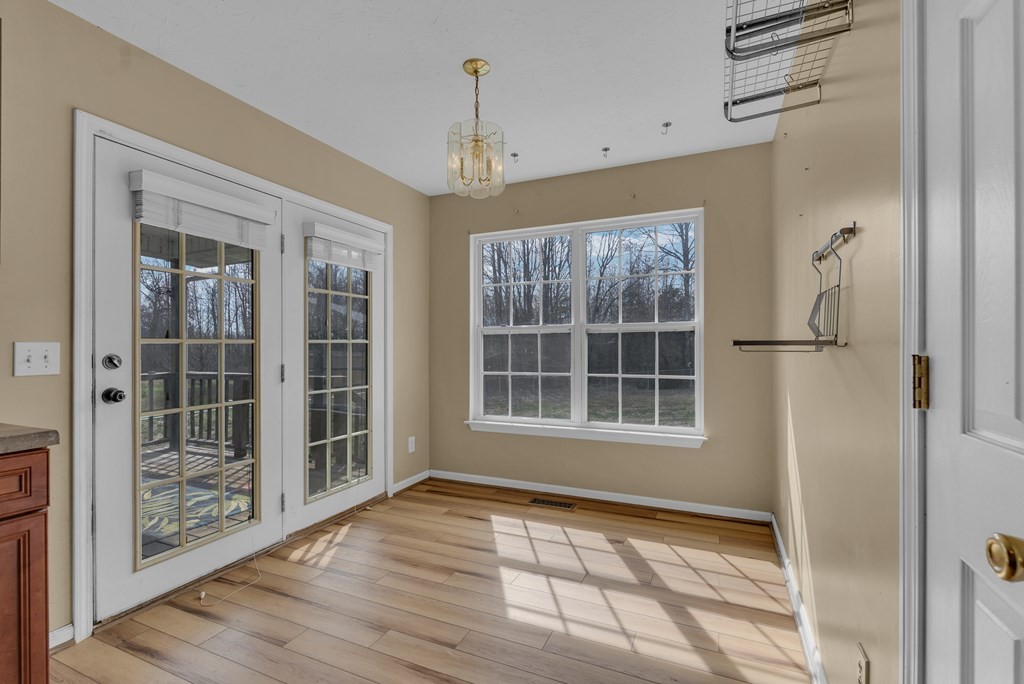 164 Prosperity Lane Sparta, TN 38583 - Photo 14 of 39 a view of an empty room with wooden floor and a window