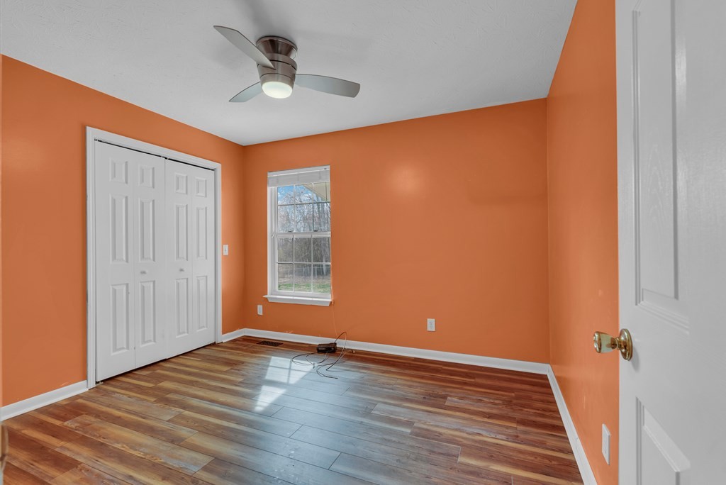 164 Prosperity Lane Sparta, TN 38583 - Photo 24 of 39 an empty room with wooden floor and windows