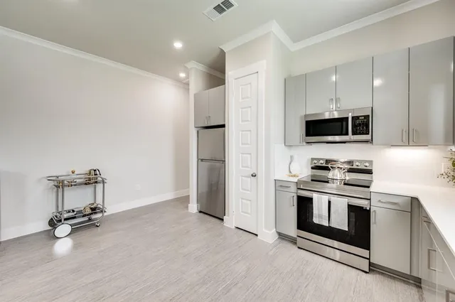 a kitchen with a stove a sink and a refrigerator