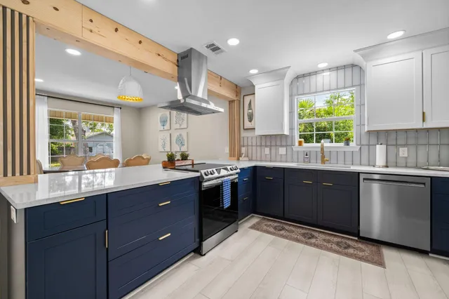 a kitchen with stainless steel appliances a sink a stove and a refrigerator