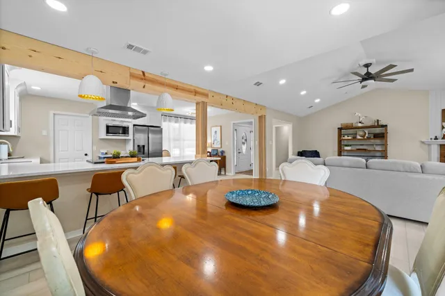 a living room with furniture ceiling fan and a window