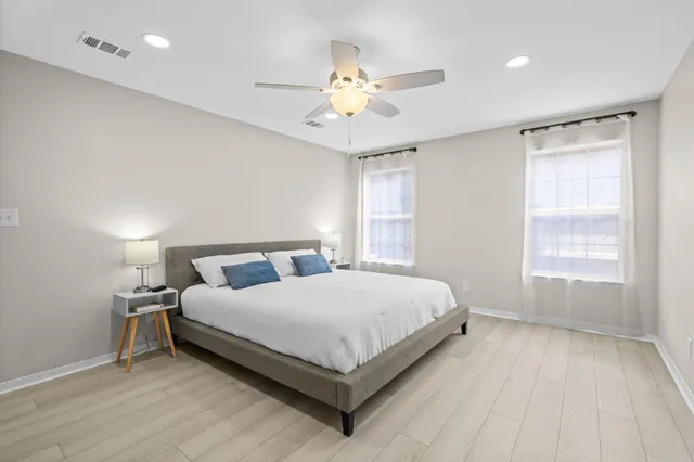 a bathroom with a sink a potted plant and a mirror
