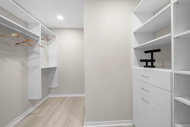 a bedroom with a bed a chair and a window