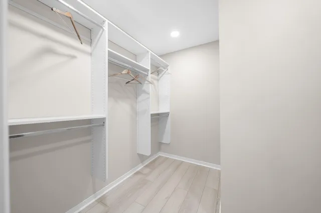 a view of a hallway with wooden floor and a hallway