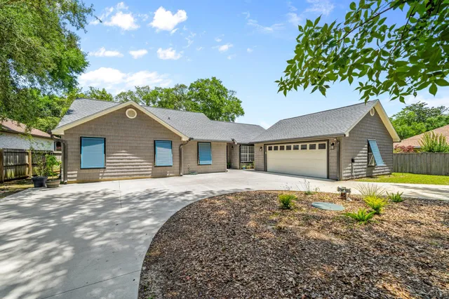 a front view of a house with potted plants