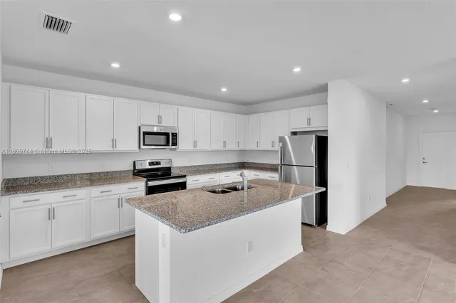a kitchen that has a sink and a stove in it