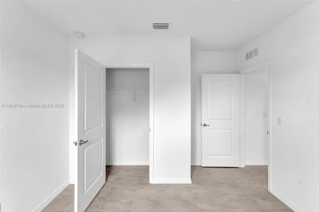 a kitchen with appliances a sink and cabinets