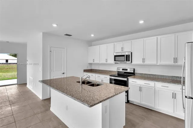 a view of an empty room and a window