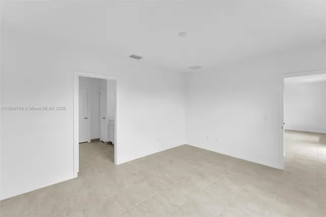 a spacious bathroom with a double vanity sink and a mirror