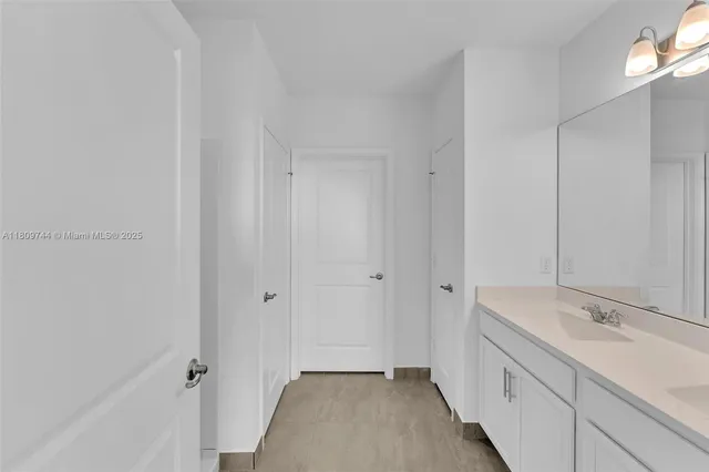 a bathroom with a double vanity sink and a mirror