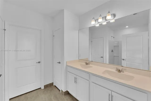 a bathroom with a sink a vanity and a mirror