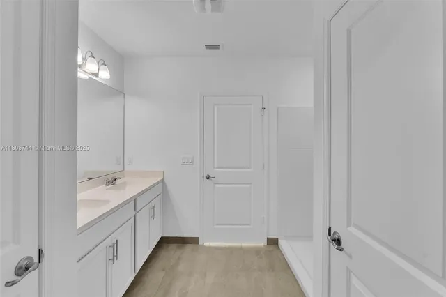 a bathroom with a sink double vanity and a mirror