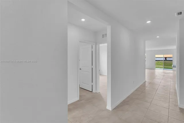 a view of a hallway with wooden shelves