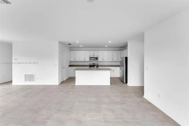 a view of kitchen with refrigerator sink and counter top