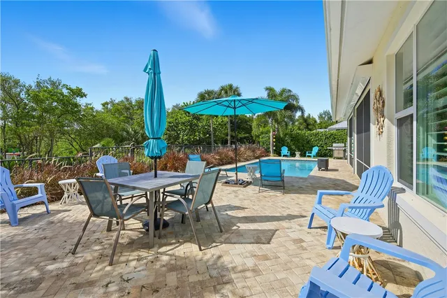 a view of a patio with table and chairs and potted plants