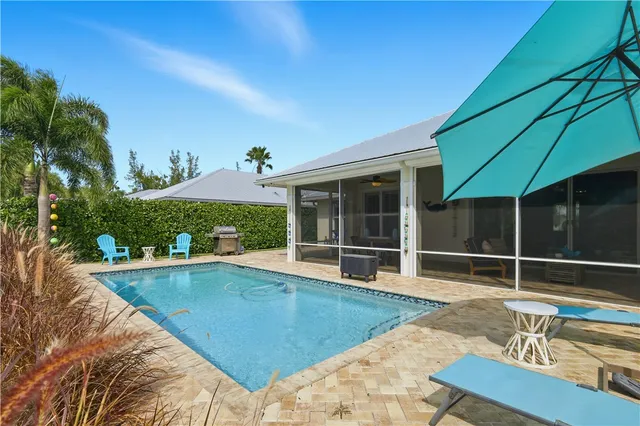 a front view of a house with a yard and potted plants