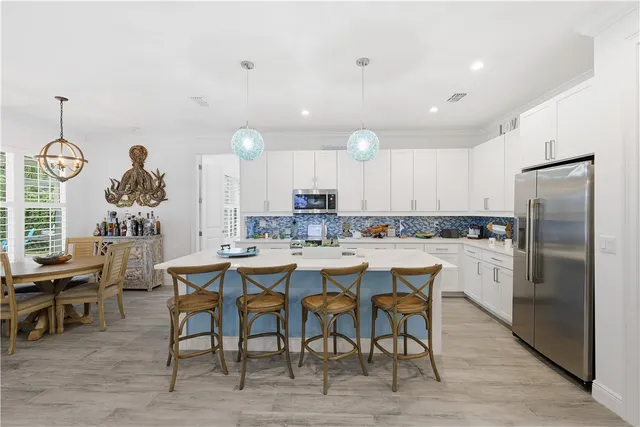 a large kitchen with a table and chairs