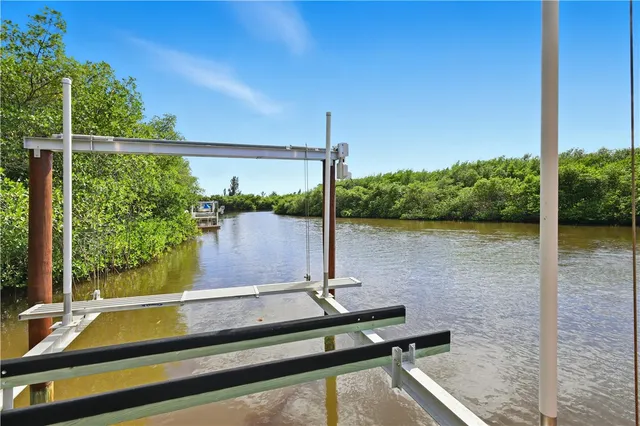 a view of a lake with a house in the background