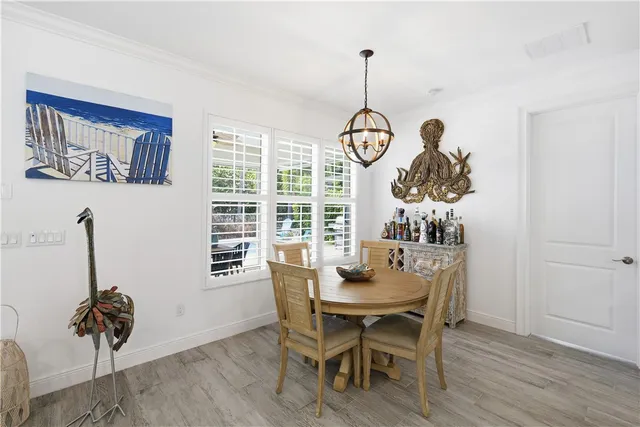 a view of a dining room and a table chairs