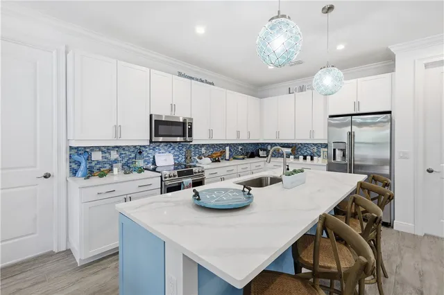 a kitchen with a stove a sink a dining table and chairs