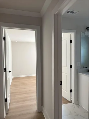 a view of a hallway with wooden floor
