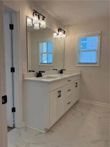 a bathroom with a double vanity sink a mirror and shower
