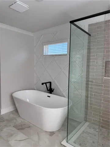 a bathroom with a bathtub and shower