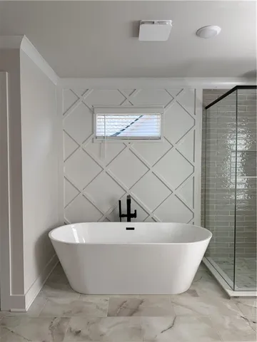 a white bath tub sitting in a bathroom