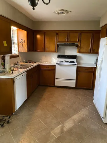 a view of a kitchen with a sink cabinet and a window