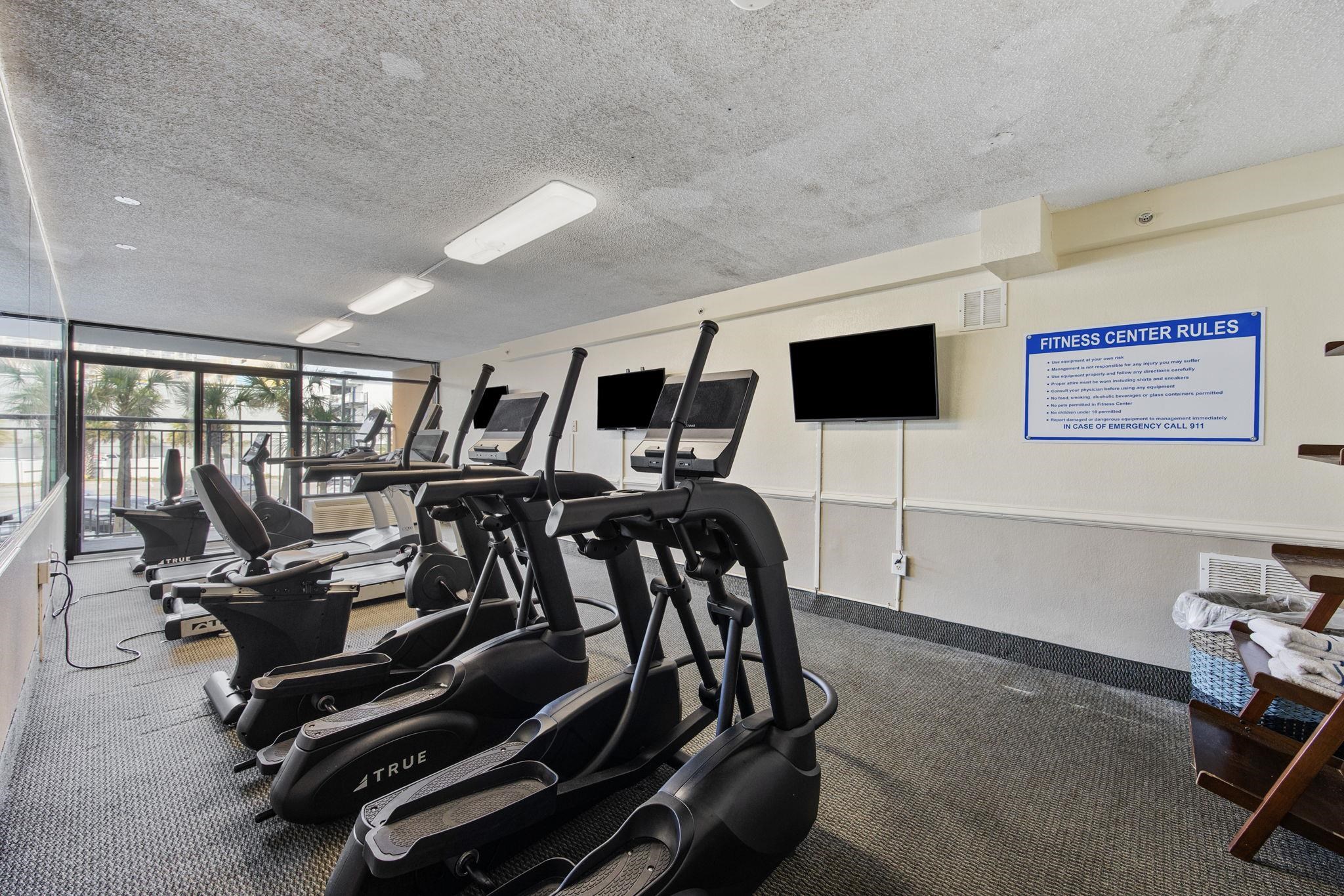 1501 South Ocean Boulevard, Unit 910 Myrtle Beach, SC 29577 - Photo 15 of 31 Exercise room featuring a textured ceiling and expansive windows