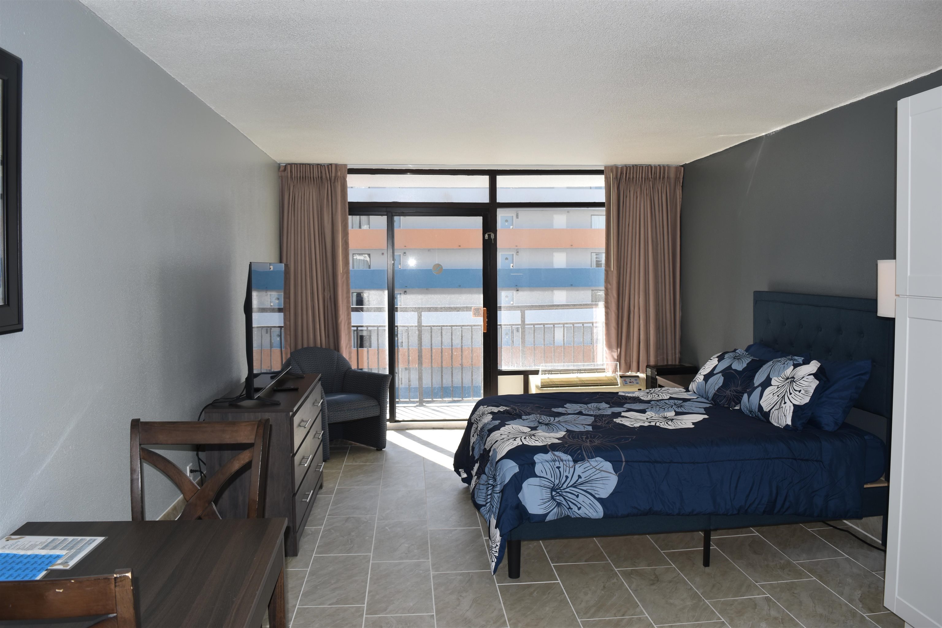 1501 South Ocean Boulevard, Unit 910 Myrtle Beach, SC 29577 - Photo 3 of 31 Bedroom featuring expansive windows and access to exterior