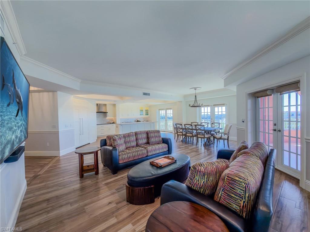 451 Bayfront Place, Unit 5407 Naples, FL 34102 - Photo 13 of 45 Living room featuring wood finished floors, french doors, and crown molding