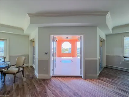 a living room with furniture a flat screen tv and a large window