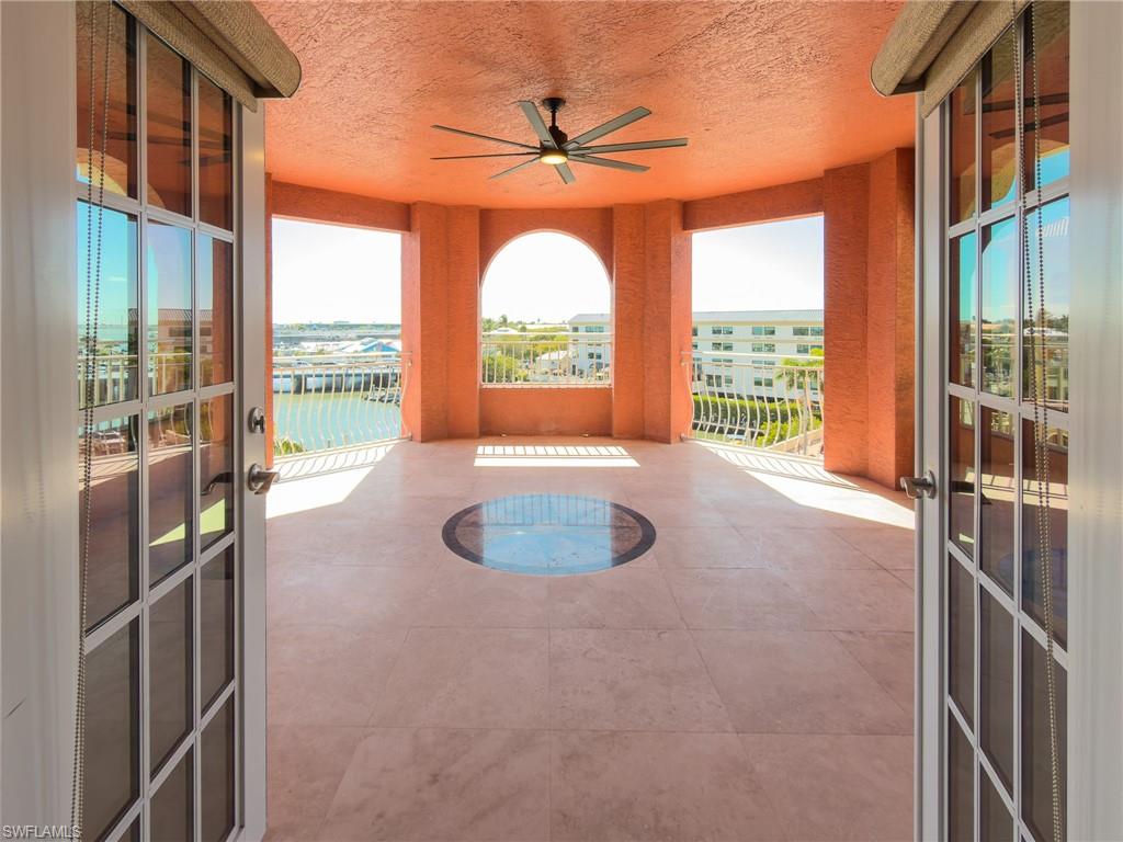 451 Bayfront Place, Unit 5407 Naples, FL 34102 - Photo 15 of 45 Unfurnished sunroom with french doors, a water view, and plenty of natural light