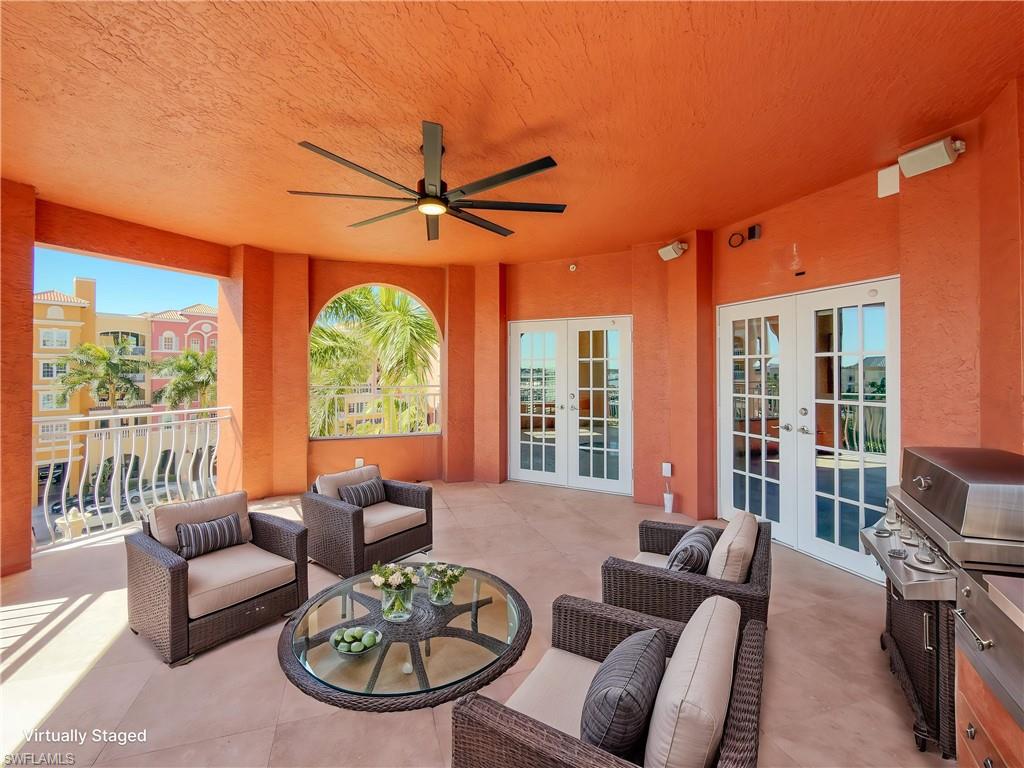 451 Bayfront Place, Unit 5407 Naples, FL 34102 - Photo 16 of 41 a living room with furniture a flat screen tv and a large window