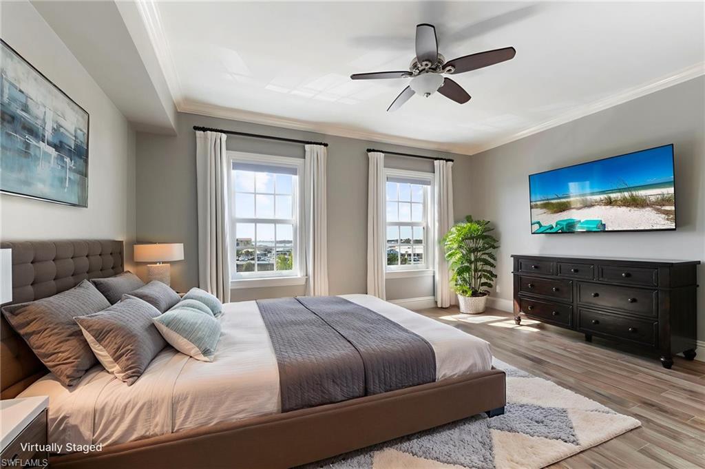 451 Bayfront Place, Unit 5407 Naples, FL 34102 - Photo 19 of 38 Bedroom with wood finished floors, ornamental molding, and ceiling fan